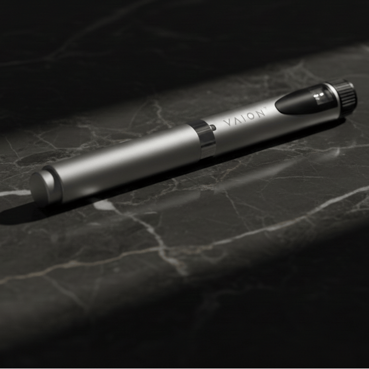 Silver pen with black accents on a dark marble surface