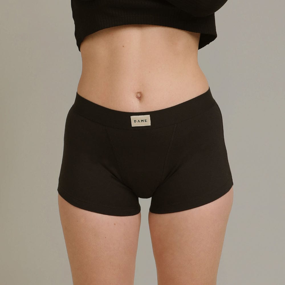 Shortie Period Pant in black organic cotton by DAME, offering leak protection and odour control for medium flow. Comfortable and breathable fit.