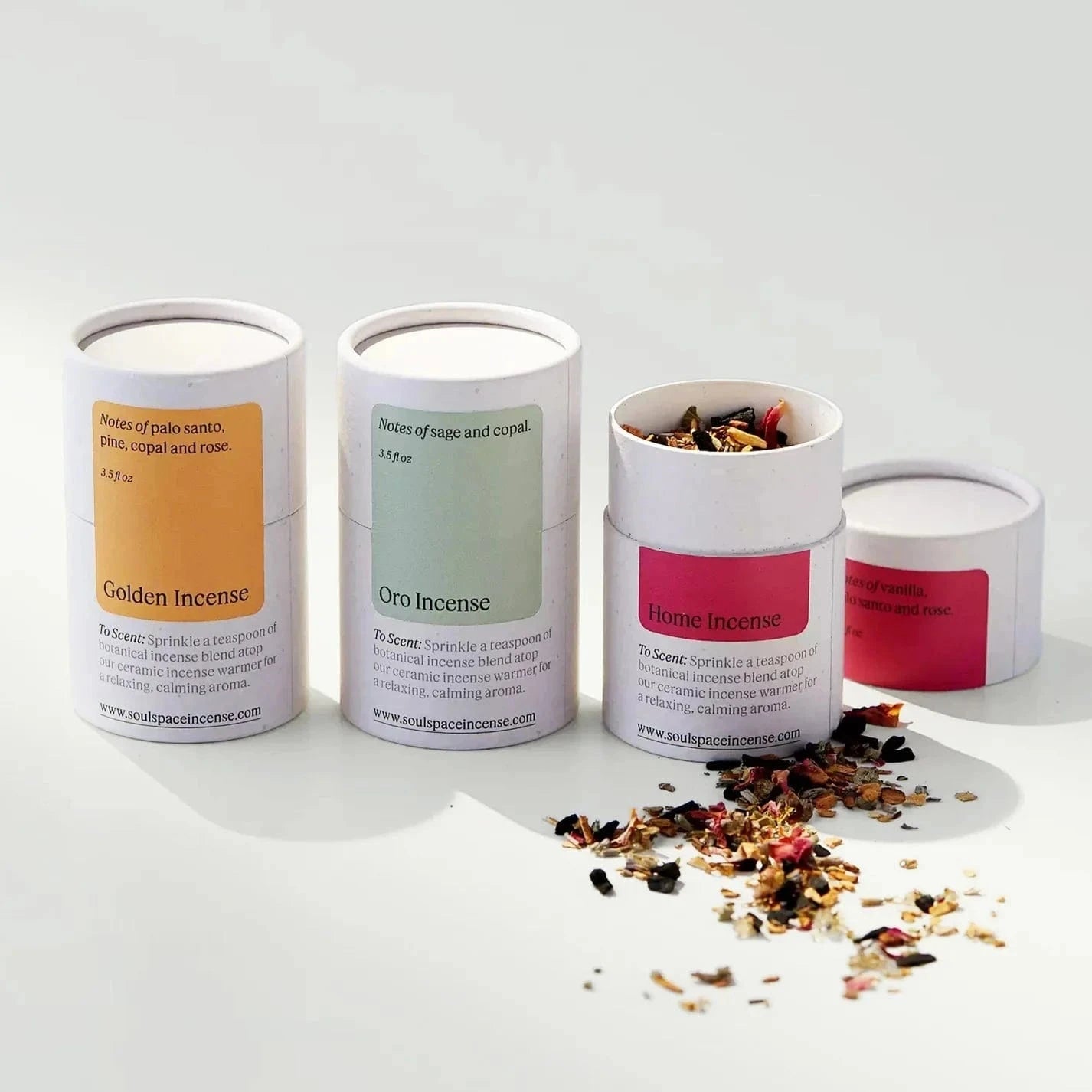 Ceramic Incense Holder Bundle with three artisan-crafted incense blends in labeled tubes: Golden, Oro, and Home Incense. Loose incense herbs spilled beside packaging.