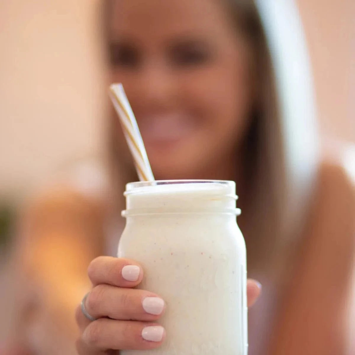 Totally Derma® 90 Days - Collagen for Radiant Skin supplement with a glass of mixed drink, ideal for skin hydration and joint health support.