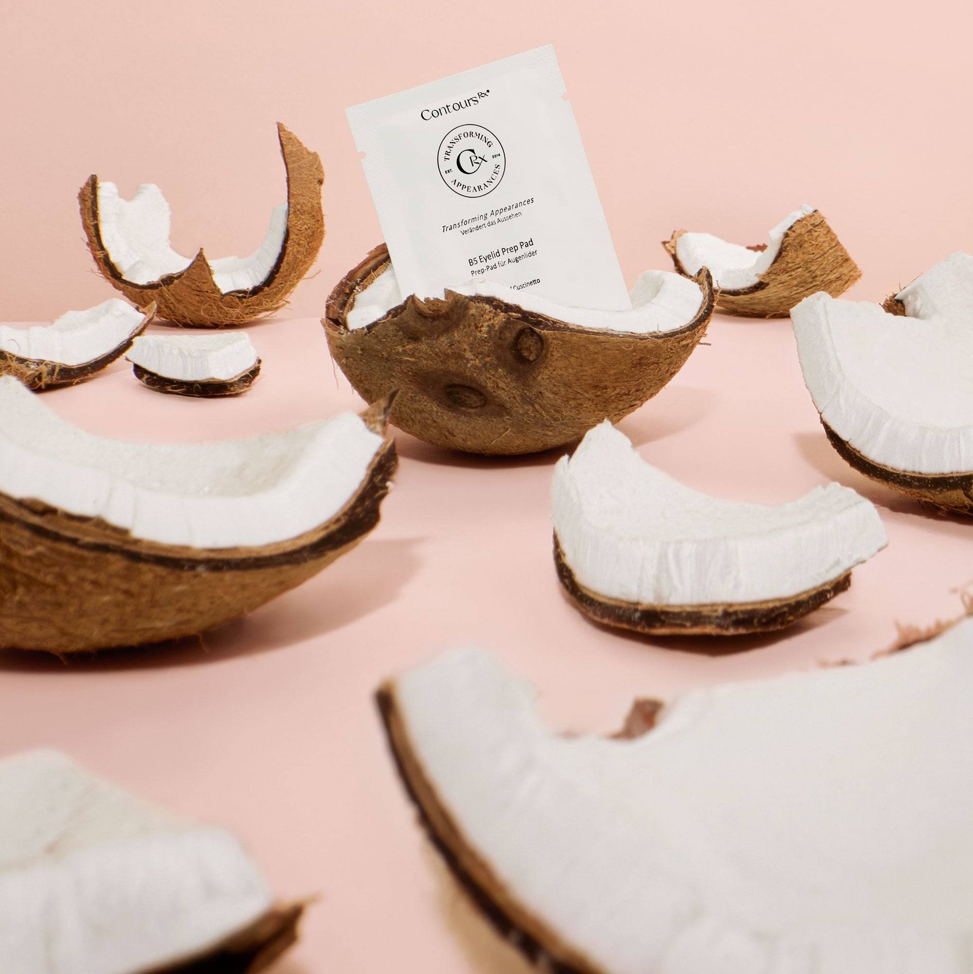 B5 Prep Pads Bundle with individual packet shown among coconut shells, highlighting natural ingredients like Coco Glucosides and Vitamin B5.