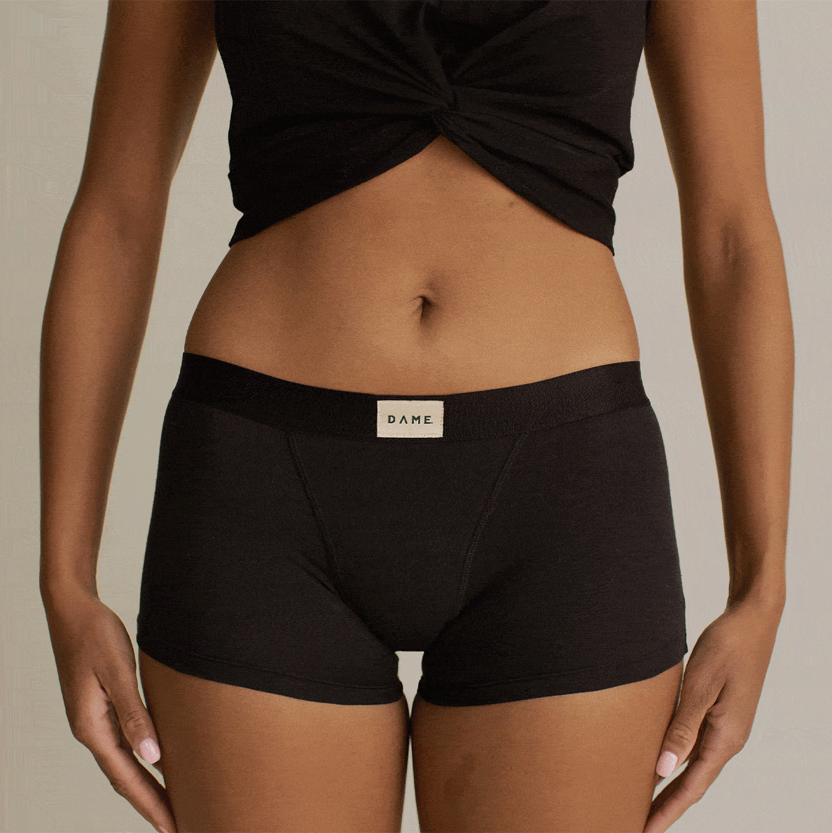 Shortie Period Pant in black organic cotton by DAME, offering leak protection and odour control for medium flow. Comfortable and breathable fit.