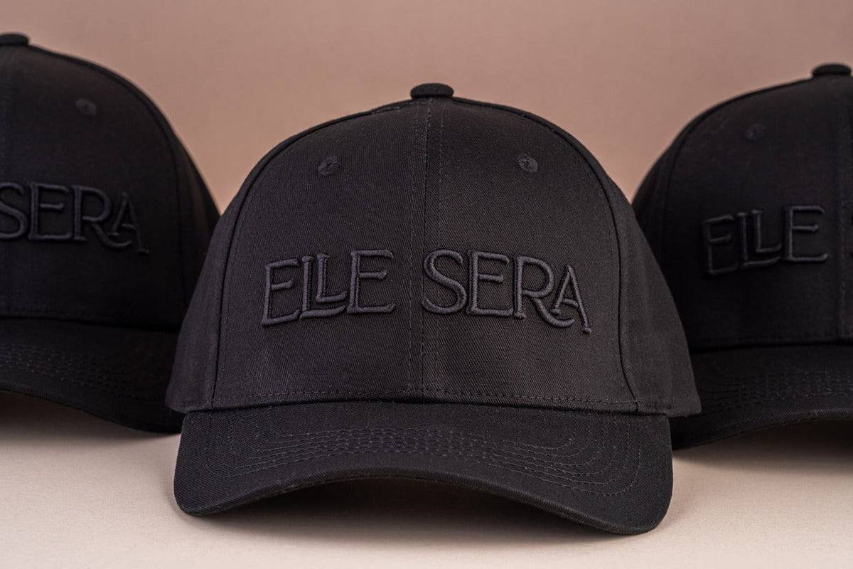 Elle Sera Cap in navy blue with bold white 3D logo embroidery, showcasing a snug fit and durable design. Stylish baseball cap for daily wear.