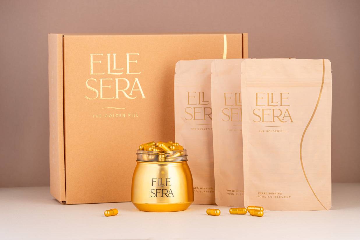 The Golden Pill Gift Set by Elle Sera featuring gold capsules in a jar, three supplement pouches, and a branded box. Energy supplement with no subscription.