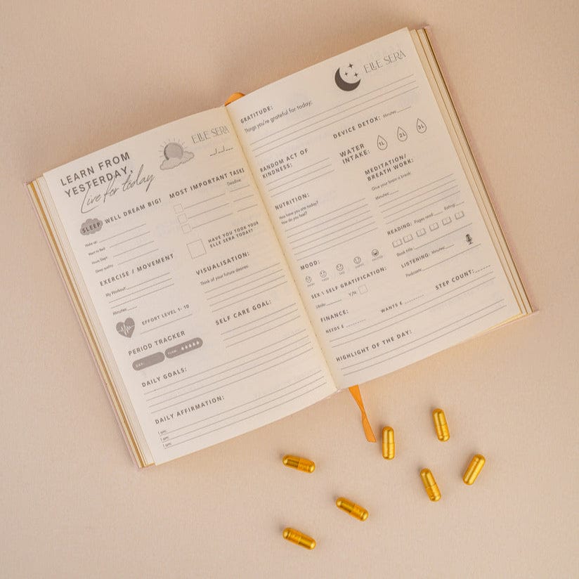 Three-Month Wellness Journal - Growth & Habits | Daily Clarity in blush pink hardcover with gold embossed text 'Be Bold Stay Gold' by Elle Sera. Ideal for tracking wellness, habits, and mindfulness.