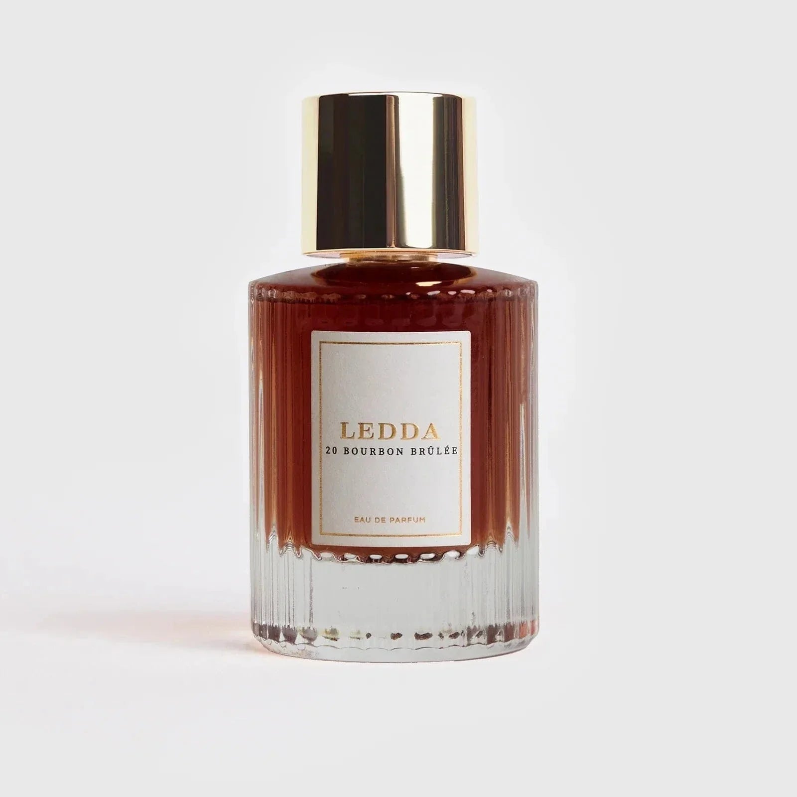 Bourbon Brûlée Eau De Parfum 50ml by Ledda in a clear ribbed glass bottle with gold cap, ideal for warm and indulgent fall scents.