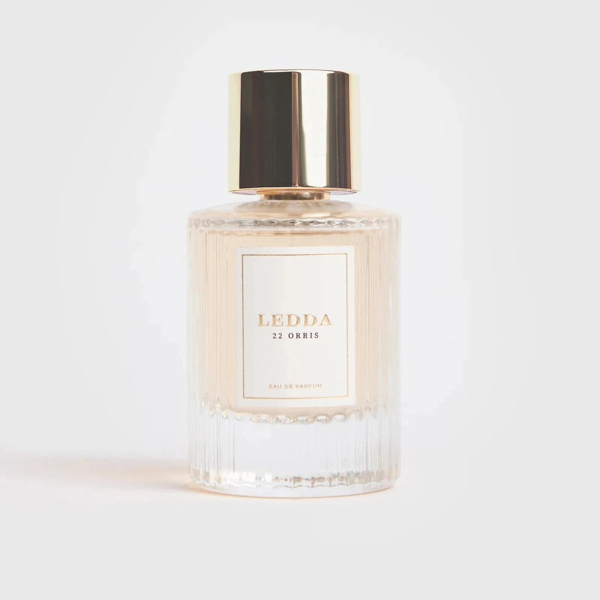 22 Orris Eau De Parfum 50ML by LEDDA with soft floral scent, featuring iris butter, jasmine, and musk in a clear ribbed glass bottle with gold cap.