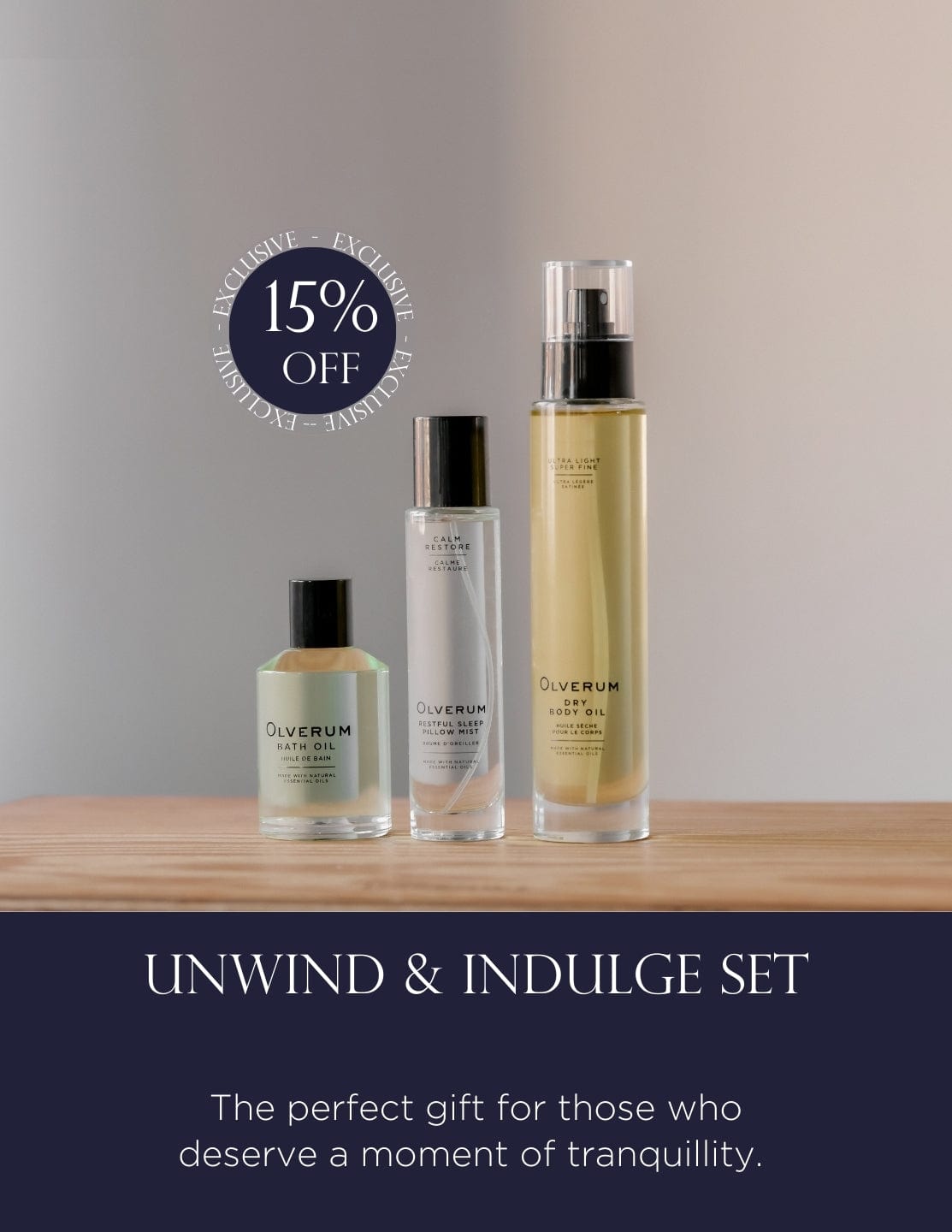 UNWIND & INDULGE SET - Luxury Bath Set with Olverum body oil, bath oil, and mist on wooden surface. Ideal relaxation gift box for self care and wellness.