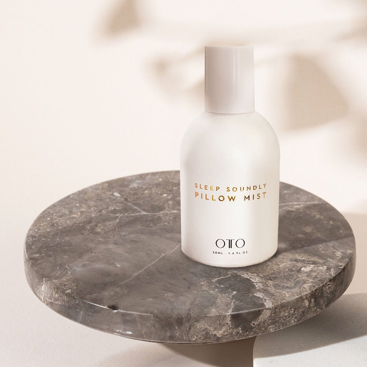 Sleep Soundly Pillow Mist by OTO in minimalist white bottle, featuring calming chamomile and lavender for restful sleep and stress relief.