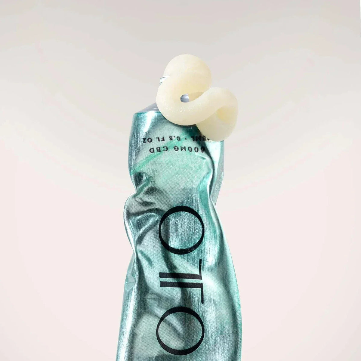 The Ultimate Balm by OTO in a sleek metallic green tube, a luxury multi-purpose skincare balm with 40 uses for deep hydration and skin relief.