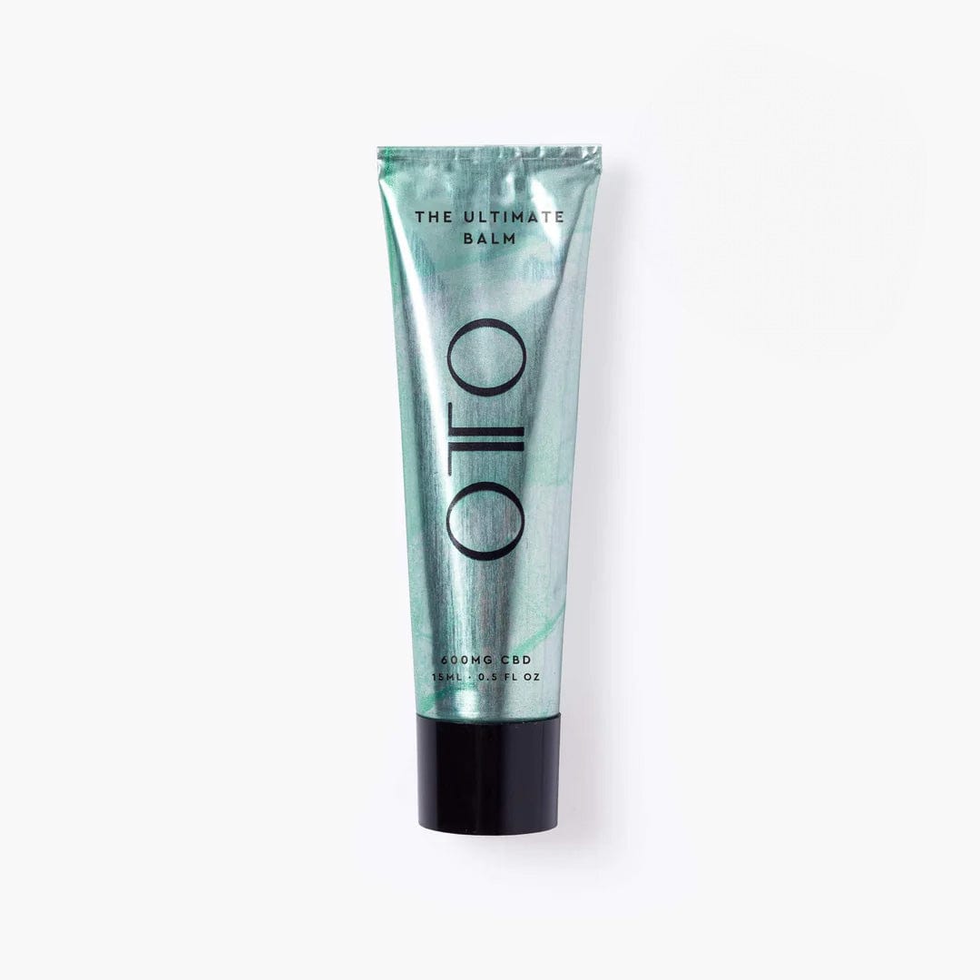 The Ultimate Balm by OTO in a sleek metallic green tube, a luxury multi-purpose skincare balm with 40 uses for deep hydration and skin relief.