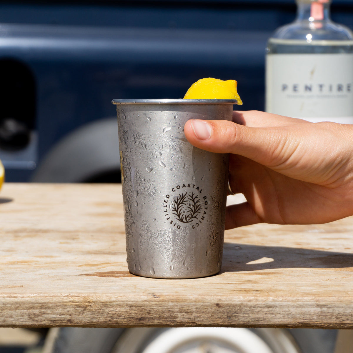 Pentire Eco Cup - Sustainable Outdoor Drinkware made from reclaimed stainless steel, shown on a wooden shelf with minimalist decor.