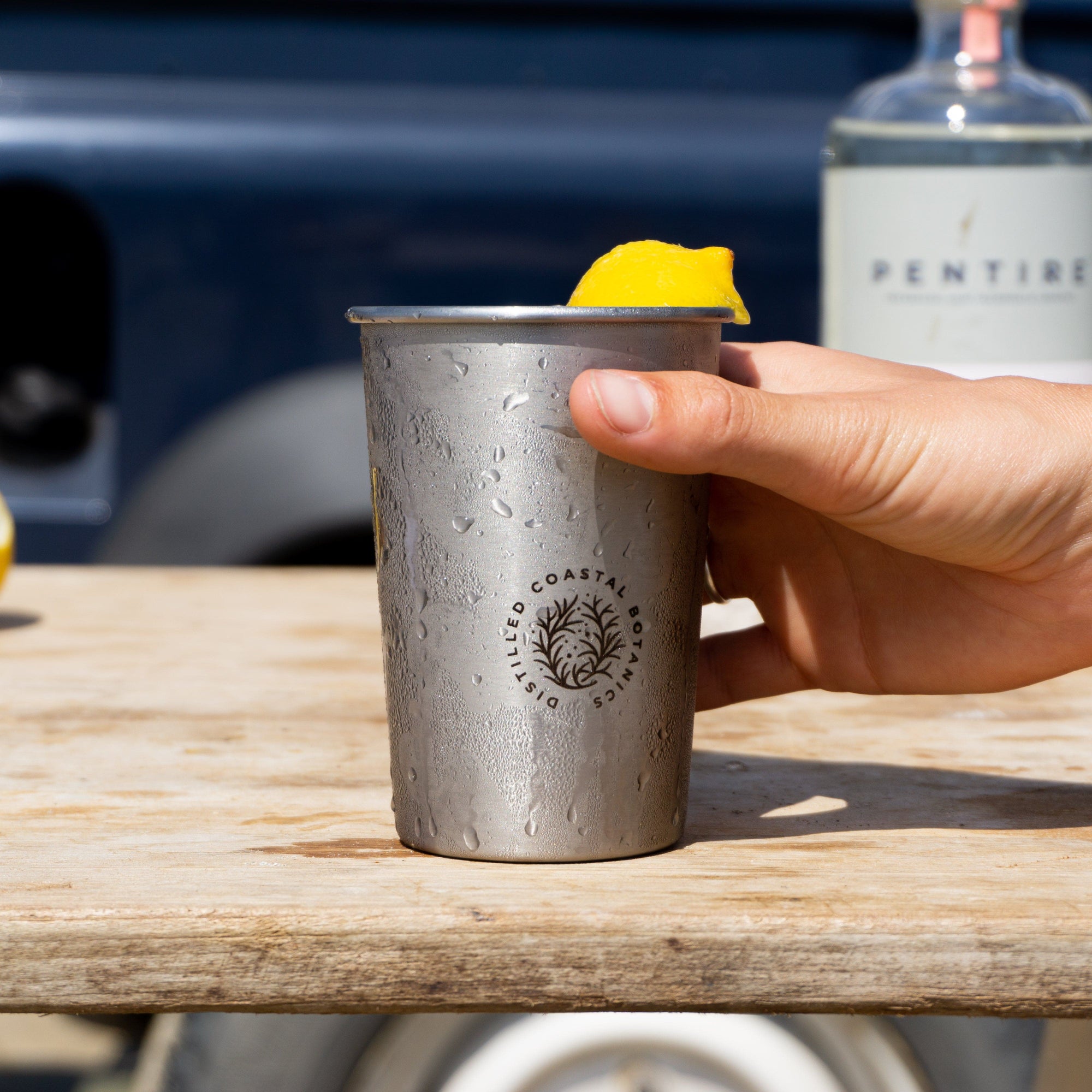 Pentire Eco Cup - Sustainable Outdoor Drinkware made from reclaimed stainless steel, shown on a wooden shelf with minimalist decor.