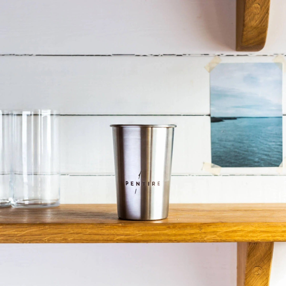 Pentire Eco Cup - Sustainable Outdoor Drinkware made from reclaimed stainless steel, shown on a wooden shelf with minimalist decor.