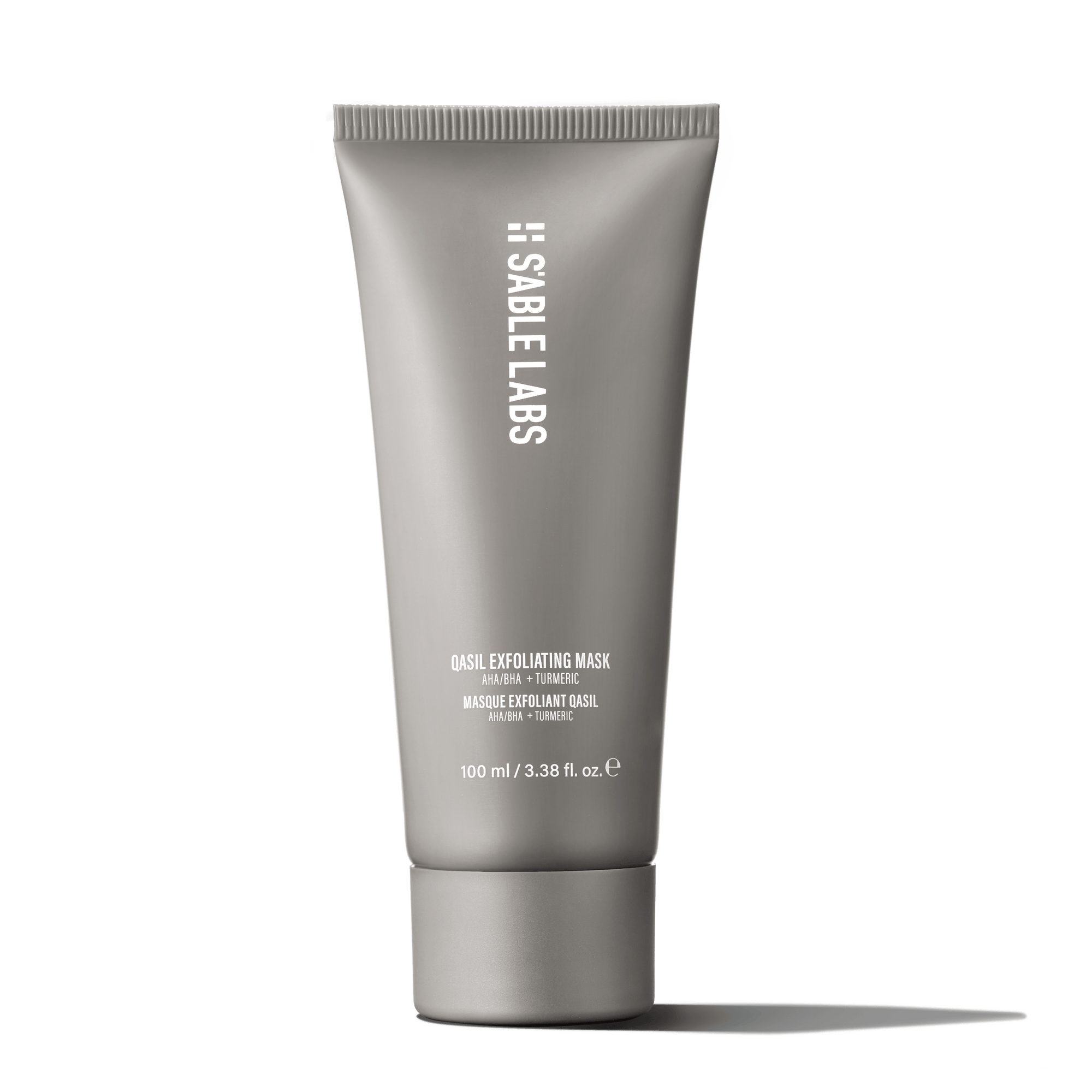 Qasil Exfoliating Mask - Brightening Face Exfoliant | AHAs, PHAs in sleek grey tube held by hand. Natural detoxifying skincare for glowing complexion.