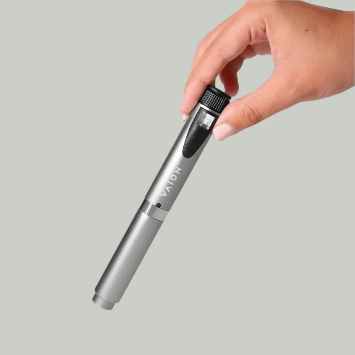 VAION+ NAD Pen - Cellular Wellness Solution | Boosts Energy. Sleek silver wellness pen held by hand, ideal for enhancing energy and focus.